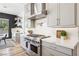 Kitchen featuring stainless steel appliances, gray cabinetry, and marble countertops and backsplash at 12155 Sage Thunder Ave, Las Vegas, NV 89138