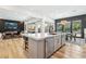 Open concept kitchen with stainless steel appliances, island seating, and access to living spaces at 12155 Sage Thunder Ave, Las Vegas, NV 89138
