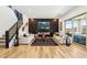 Spacious living room with a modern fireplace, staircase, and hardwood flooring throughout at 12155 Sage Thunder Ave, Las Vegas, NV 89138