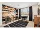 Modern room with a piano, armchairs, an area rug, and a guitar-themed wall at 12155 Sage Thunder Ave, Las Vegas, NV 89138