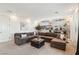 Spacious living room featuring a large sectional sofa, carpet flooring, and a striking race car themed wall graphic at 12155 Sage Thunder Ave, Las Vegas, NV 89138