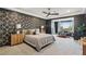 Stunning main bedroom featuring a geometric accent wall and sitting area with lots of natural light at 12155 Sage Thunder Ave, Las Vegas, NV 89138