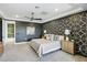Comfortable main bedroom features geometric accent wall and ensuite bathroom at 12155 Sage Thunder Ave, Las Vegas, NV 89138