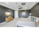 Spacious main bedroom showcasing a dark accent wall, television, and ensuite bathroom access at 12155 Sage Thunder Ave, Las Vegas, NV 89138