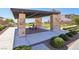 Covered picnic area featuring stone pillars, a metal roof, and a table with benches overlooking the neighborhood at 12155 Sage Thunder Ave, Las Vegas, NV 89138