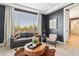 Cozy sitting room boasts stylish furniture, a cowhide rug, and a bright window view at 12155 Sage Thunder Ave, Las Vegas, NV 89138