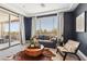 Bright sitting room with stylish decor, cowhide rug, and access to a large balcony at 12155 Sage Thunder Ave, Las Vegas, NV 89138