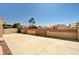 This backyard has a neutral-colored block wall and a patio area at 1536 Leatherleaf Dr, Las Vegas, NV 89123