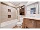 Well-lit bathroom featuring a tiled shower-tub combo and a modern vanity with ample storage at 1536 Leatherleaf Dr, Las Vegas, NV 89123