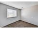 This bedroom features a window and neutral-colored walls and carpeting at 1536 Leatherleaf Dr, Las Vegas, NV 89123