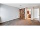 This carpeted bedroom includes a barn door and access to an en-suite bathroom at 1536 Leatherleaf Dr, Las Vegas, NV 89123