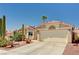 View of a single-story home featuring desert landscaping, tile roof, and attached two-car garage at 1536 Leatherleaf Dr, Las Vegas, NV 89123