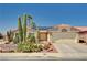 Charming single-story home with desert landscaping, tile roof and solar panels on a sunny day at 1536 Leatherleaf Dr, Las Vegas, NV 89123