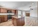 Kitchen with wood-style flooring, central island, granite countertops, cabinetry and black appliances at 1536 Leatherleaf Dr, Las Vegas, NV 89123