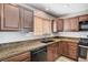 Kitchen features granite countertops, cabinetry, stainless steel appliances and wood-style flooring at 1536 Leatherleaf Dr, Las Vegas, NV 89123