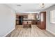 Well-lit kitchen featuring wood-style flooring, central island, and dark wood cabinetry at 1536 Leatherleaf Dr, Las Vegas, NV 89123