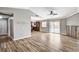 Spacious living room featuring wood floors, ceiling fan, sliding glass doors to the patio, and decorative wood wall at 1536 Leatherleaf Dr, Las Vegas, NV 89123