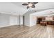 View of a living room with wood flooring, ceiling fan, and open access to the kitchen at 1536 Leatherleaf Dr, Las Vegas, NV 89123