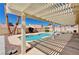 Covered patio overlooks this backyard pool surrounded by desert landscaping at 1536 Leatherleaf Dr, Las Vegas, NV 89123