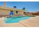 Sparkling blue swimming pool with a baja step and a shaded patio area at 1536 Leatherleaf Dr, Las Vegas, NV 89123