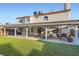 Expansive backyard with a covered patio and lush artificial grass area at 1538 Pony Ranch Cir, Henderson, NV 89014