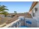Charming balcony featuring a blue table and chair, offering serene neighborhood views at 1538 Pony Ranch Cir, Henderson, NV 89014
