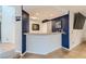 Chic bar area with dark blue textured accent wall and modern decor at 1538 Pony Ranch Cir, Henderson, NV 89014
