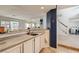 Open bar area featuring a sink, countertop, and views of living spaces at 1538 Pony Ranch Cir, Henderson, NV 89014