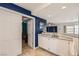 Stylish bar area with modern cabinets, sink, and unique blue wall accent at 1538 Pony Ranch Cir, Henderson, NV 89014