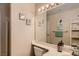 Bathroom featuring a single vanity, a large mirror, decorative shelving, and a mermaid themed decor at 1538 Pony Ranch Cir, Henderson, NV 89014