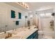 Updated bathroom featuring dual sinks, modern vanity, and bathtub with shower at 1538 Pony Ranch Cir, Henderson, NV 89014