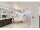 Large primary bathroom with a soaking tub, separate shower, fireplace, and dual sinks at 1538 Pony Ranch Cir, Henderson, NV 89014