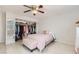 Spacious bedroom with open closet, natural light, ceiling fan, and seating at 1538 Pony Ranch Cir, Henderson, NV 89014