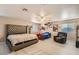 Spacious bedroom featuring a king bed, twin bed, light walls and wood-look floors at 1538 Pony Ranch Cir, Henderson, NV 89014