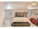 Well-lit bedroom with a tufted headboard, twin bed, and clean light wood-look floors at 1538 Pony Ranch Cir, Henderson, NV 89014