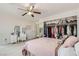 Large bedroom with open closet, ceiling fan, natural light, and a white dresser at 1538 Pony Ranch Cir, Henderson, NV 89014