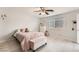 Cozy bedroom with natural light, ceiling fan, and a pink upholstered bench at 1538 Pony Ranch Cir, Henderson, NV 89014