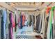 Walk-in closet with lots of clothing and storage shelves at 1538 Pony Ranch Cir, Henderson, NV 89014