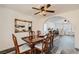 Dining room view showcases wood floors, traditional furniture, and open flow to an archway into the Gathering room at 1538 Pony Ranch Cir, Henderson, NV 89014