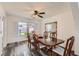 Dining room with wood floors, traditional table/chairs, and a large window providing natural light at 1538 Pony Ranch Cir, Henderson, NV 89014