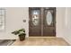 Elegant double front doors with decorative glass inserts and neutral tile flooring at 1538 Pony Ranch Cir, Henderson, NV 89014