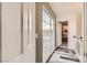 Hallway with wood-look flooring and a door to a bedroom that lets in a great amount of natural light at 1538 Pony Ranch Cir, Henderson, NV 89014