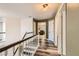 Hallway view featuring wood-look floors, multiple doors, and stairs leading up at 1538 Pony Ranch Cir, Henderson, NV 89014