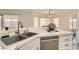 Bright kitchen featuring a stainless steel dishwasher, double sinks, and ample counter space at 1538 Pony Ranch Cir, Henderson, NV 89014