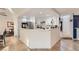 Open kitchen with white cabinets, stainless steel appliances, and a breakfast bar at 1538 Pony Ranch Cir, Henderson, NV 89014