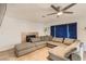 Spacious living room featuring a large gray sectional couch, fireplace, and neutral decor at 1538 Pony Ranch Cir, Henderson, NV 89014