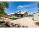 Expansive backyard with artificial grass, a covered patio, and low-maintenance desert landscaping at 1673 Golden Vista Dr, Las Vegas, NV 89123