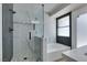 Modern bathroom featuring a glass-enclosed shower, soaking tub, and stylish tile work at 1673 Golden Vista Dr, Las Vegas, NV 89123