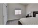 Cozy bedroom with soft carpet, a bedside table, a window, and neutral decor at 1673 Golden Vista Dr, Las Vegas, NV 89123