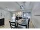Bright dining area boasts modern light fixture and sliders to backyard patio with artificial turf at 1673 Golden Vista Dr, Las Vegas, NV 89123